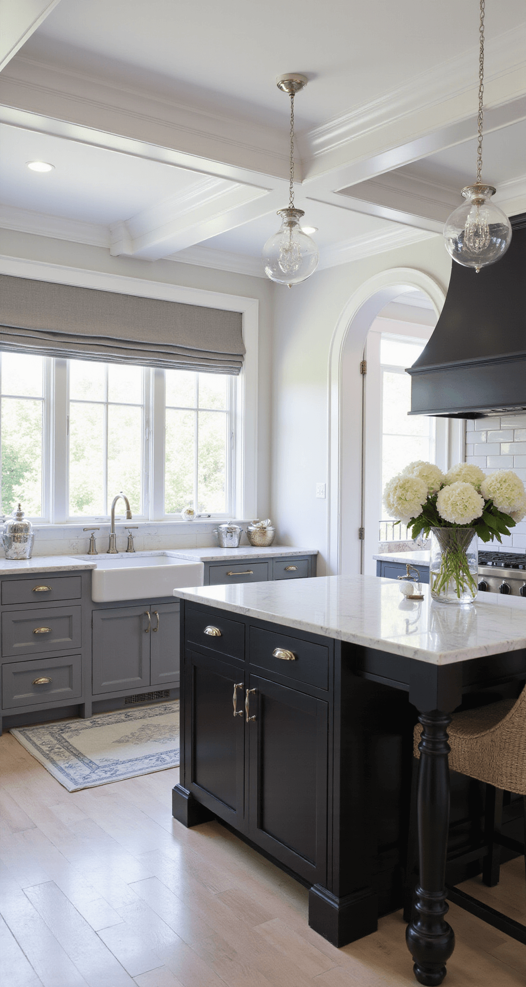 16x20ft kitchen with a white coffered ceiling, arched doorways, matte and glossy black cabinets, marble backsplash, and polished nickel hardware, featuring recessed lighting, glass globe pendants, and styled with white hydrangeas and silver pieces.